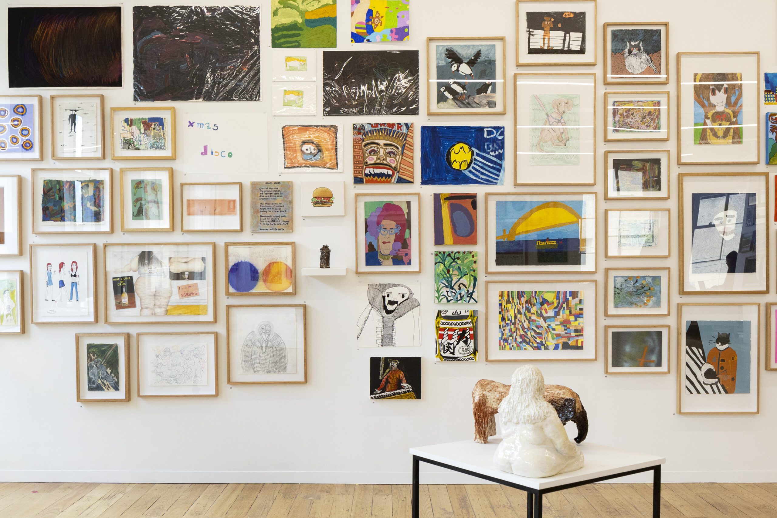 A photo of artworks hung in a salon style at the APA gallery