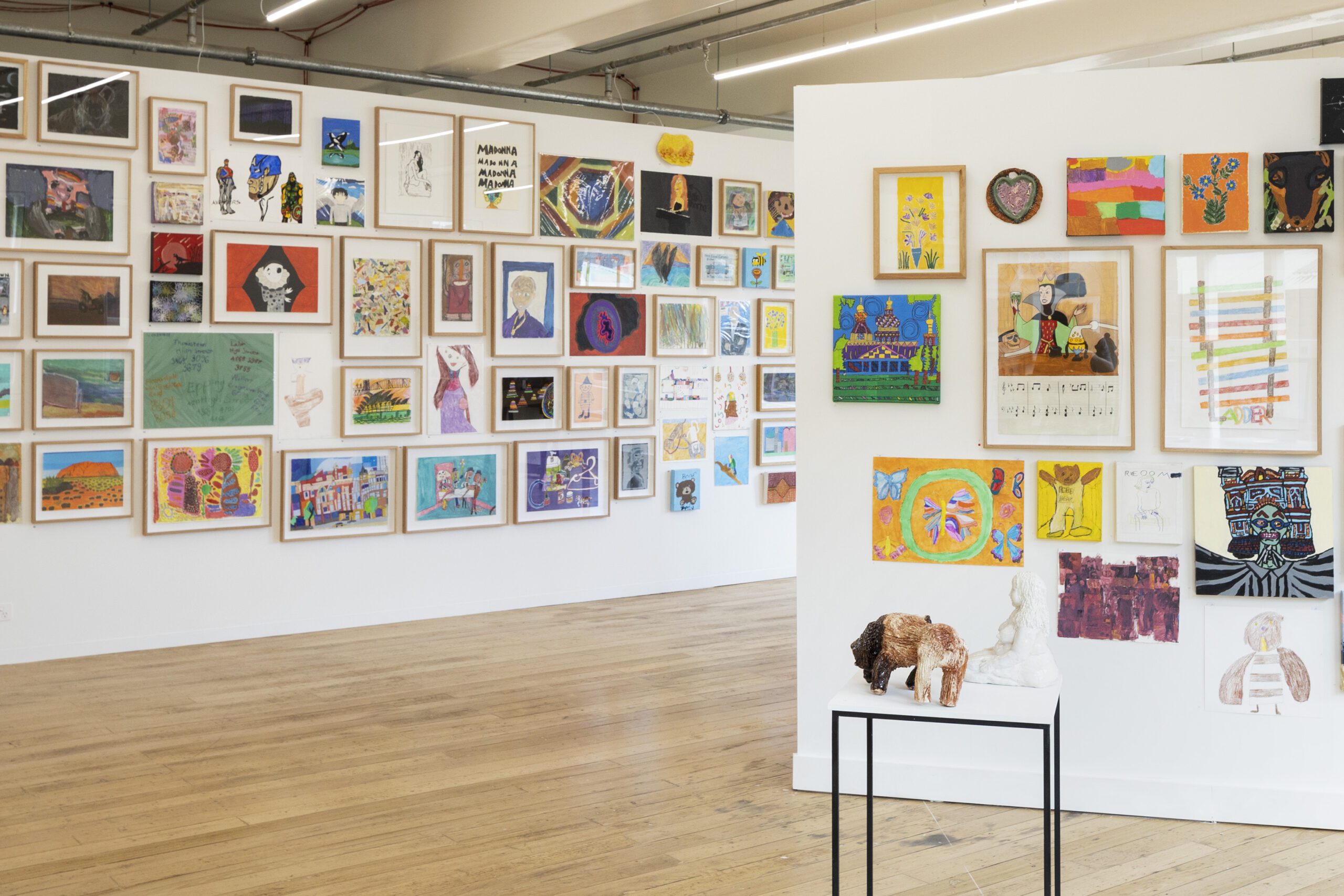 A photo of artworks hung in a salon style at the APA gallery