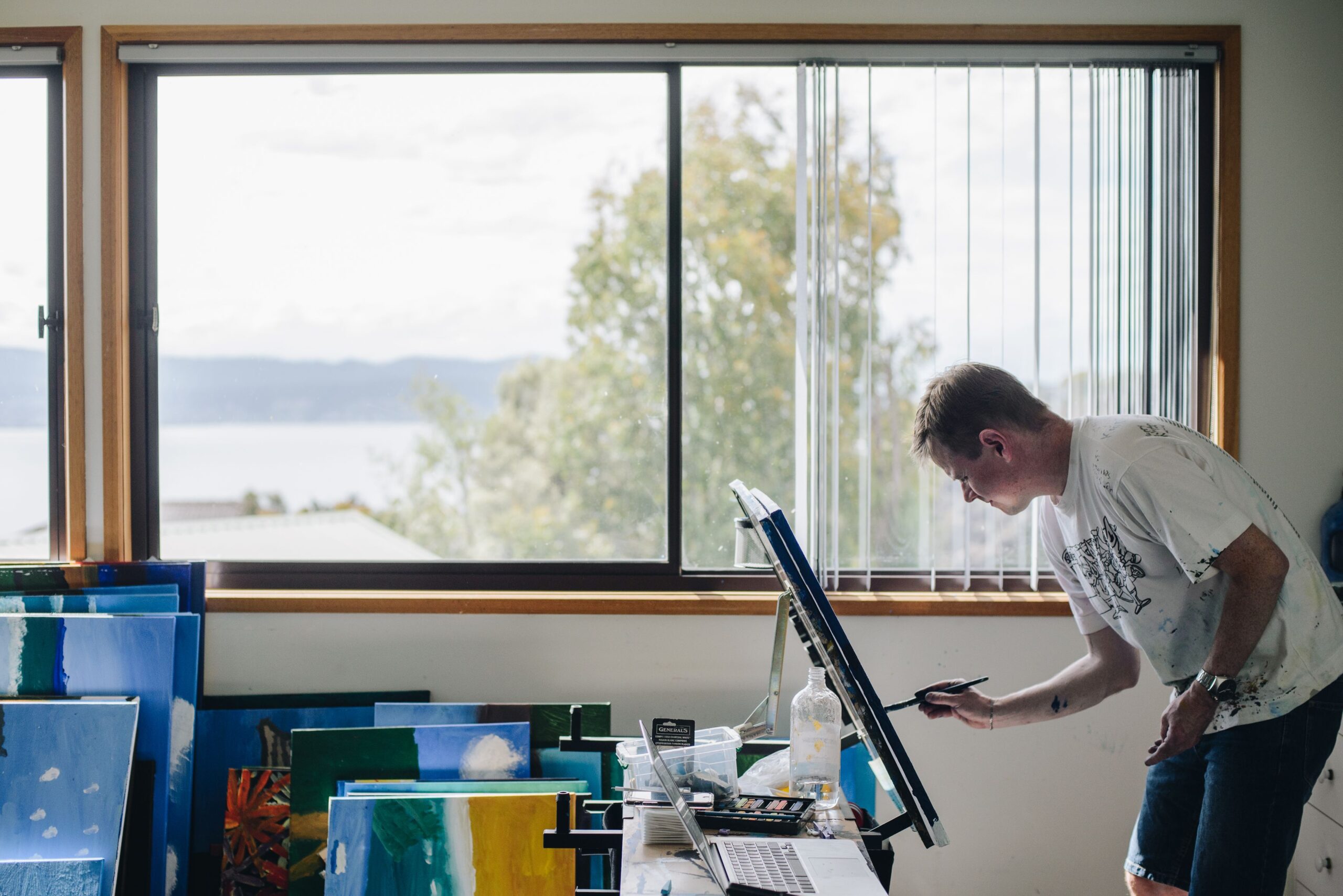 Michael McQuillan painting in his home studio.