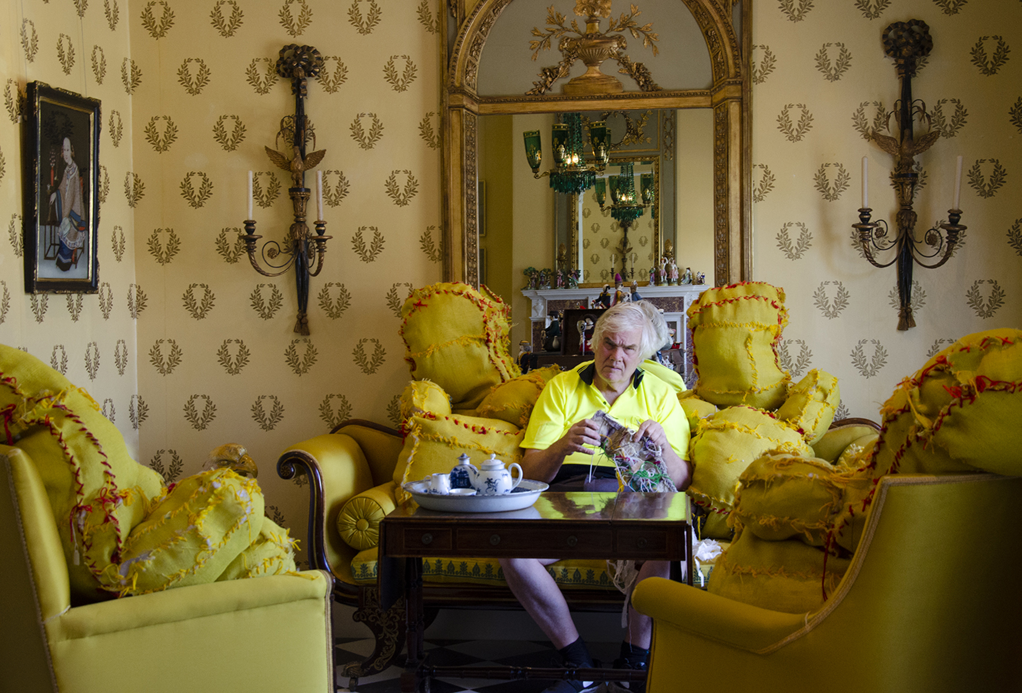 Terry Williams sitting amongst his yellow soft sculptures