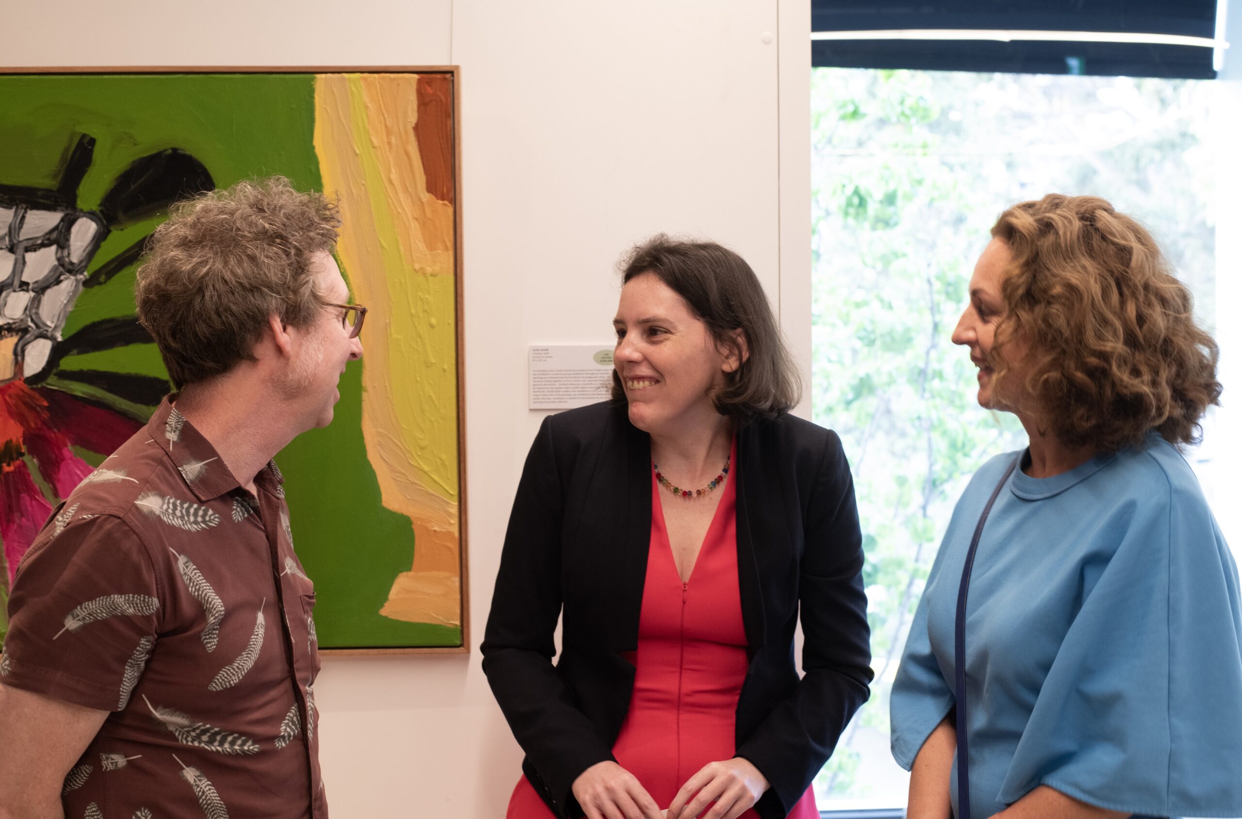 Three people in conversation at the Leonard Joel Auction rooms