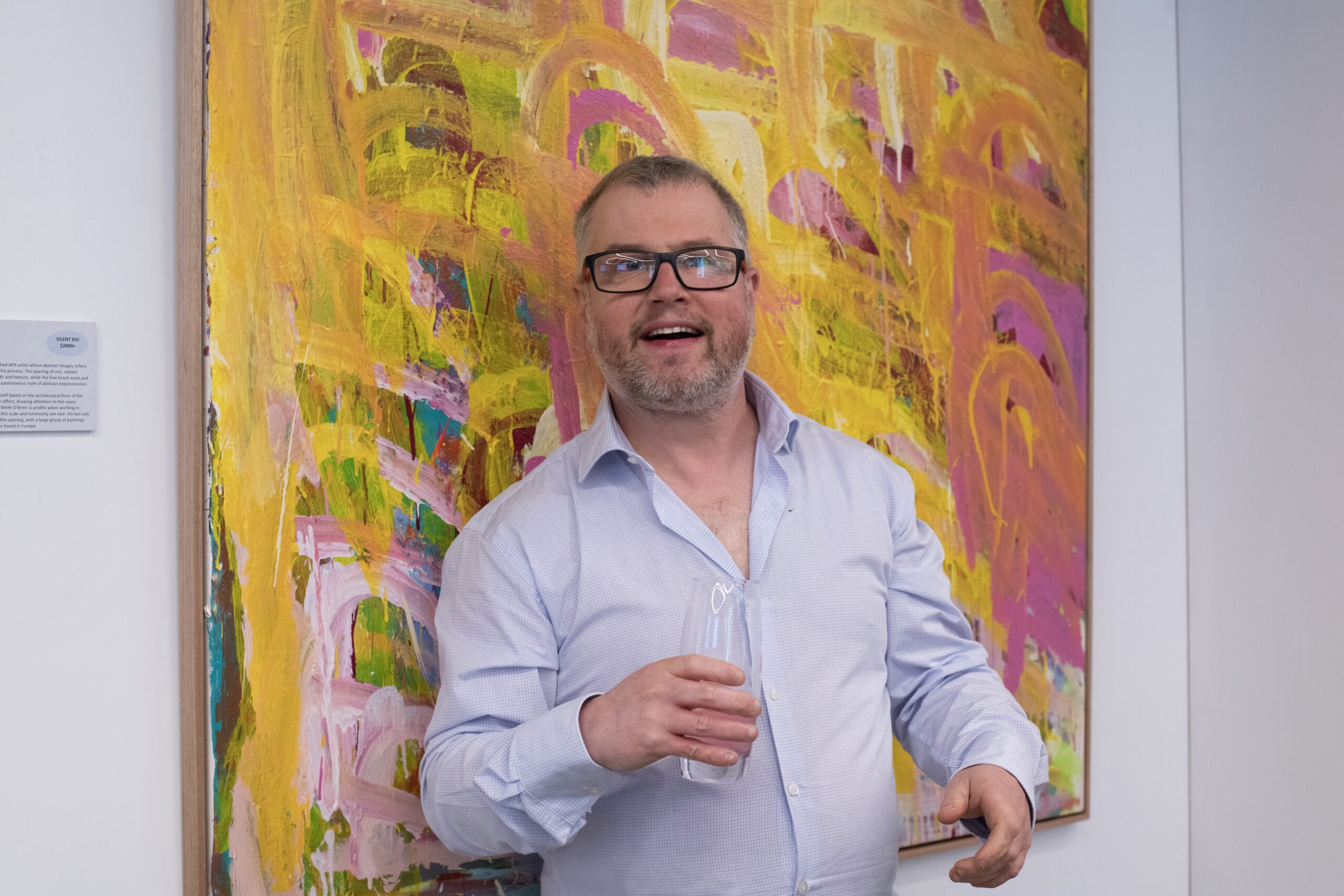 APA artist Warren O'Brien standing in front of his painting