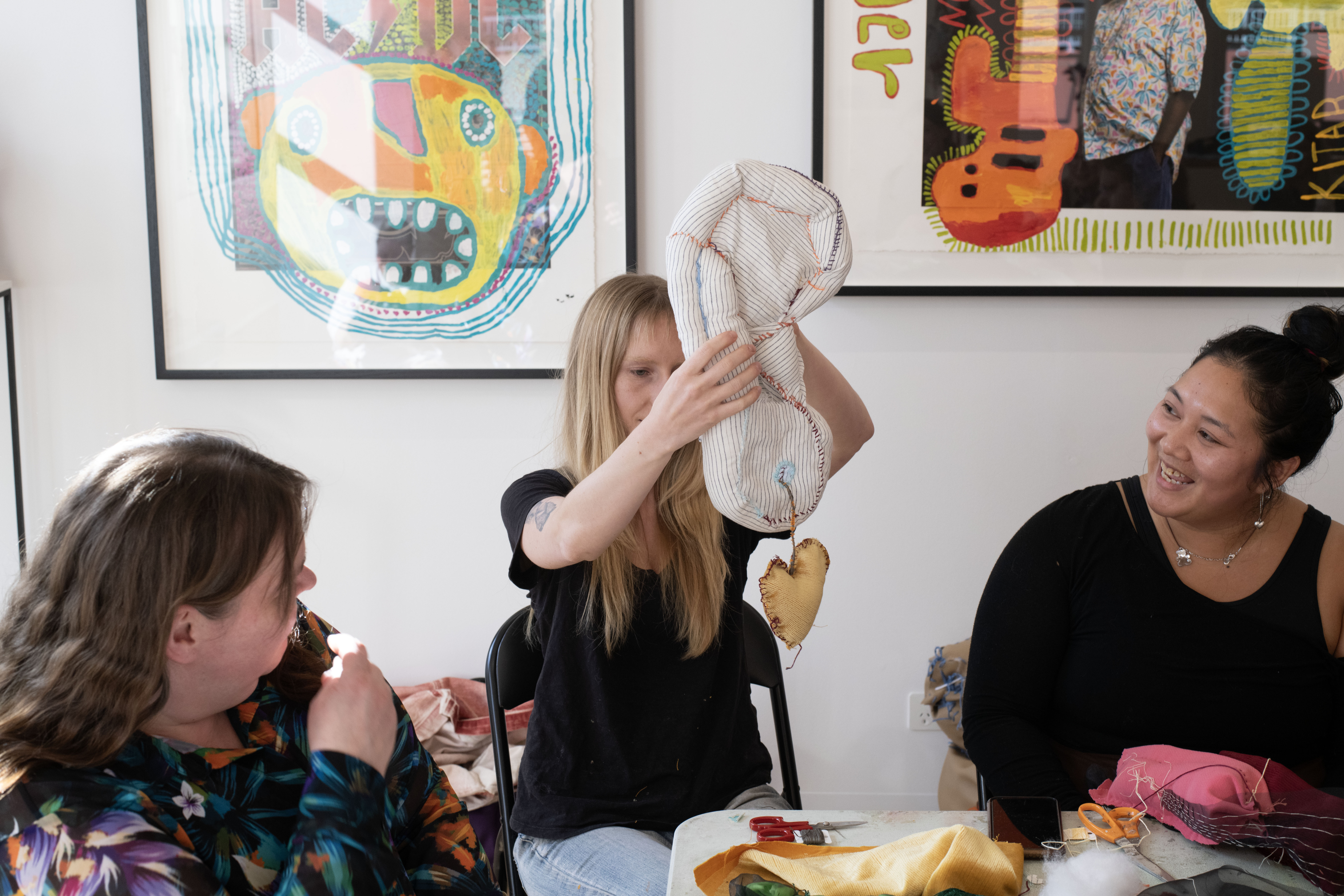Make Your Own Body Parts Workshop participant holding up their jewellery adorned earring