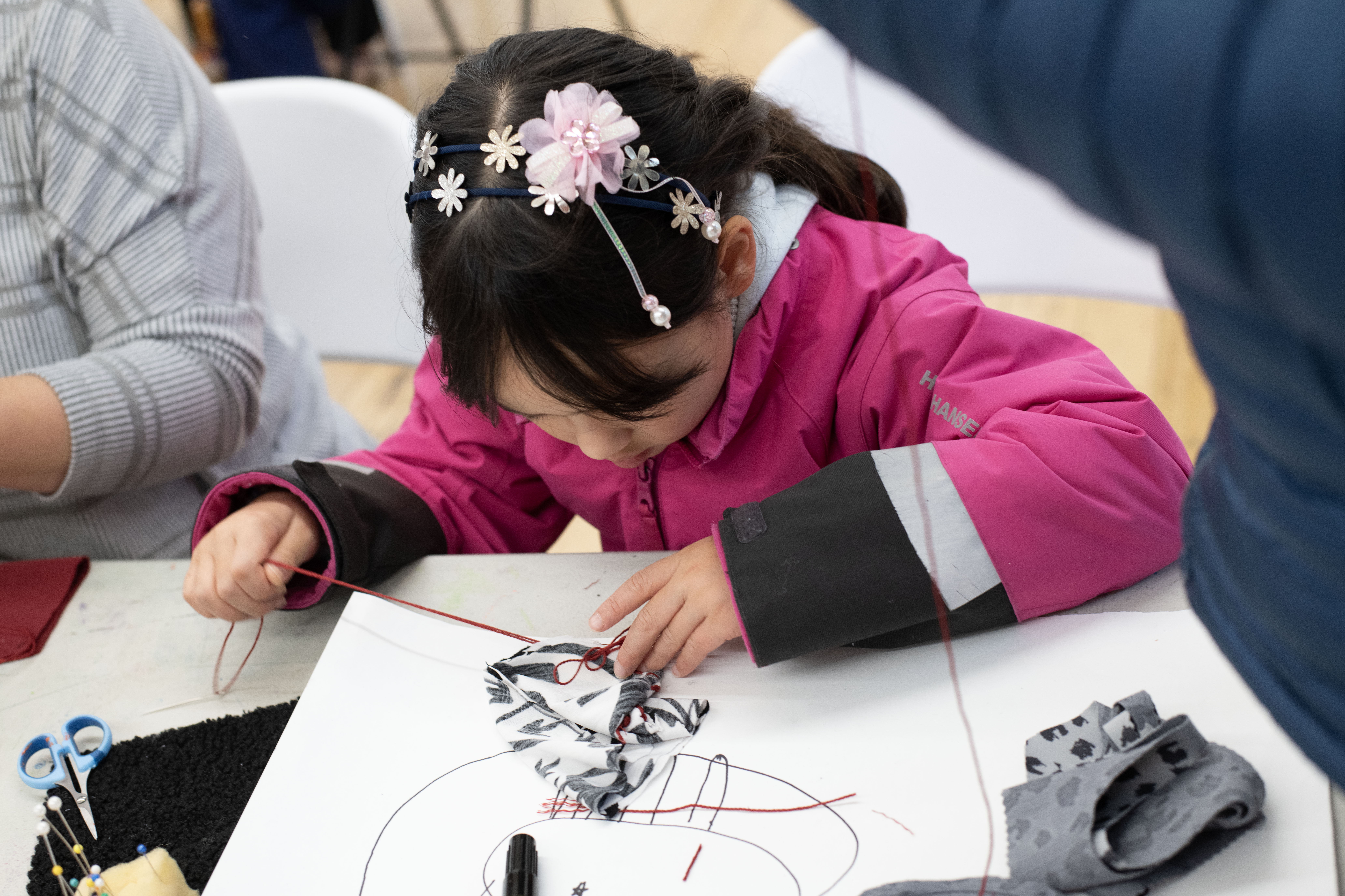 A participant drawing the outline of their creature in the Strange Creature Creations Workshop