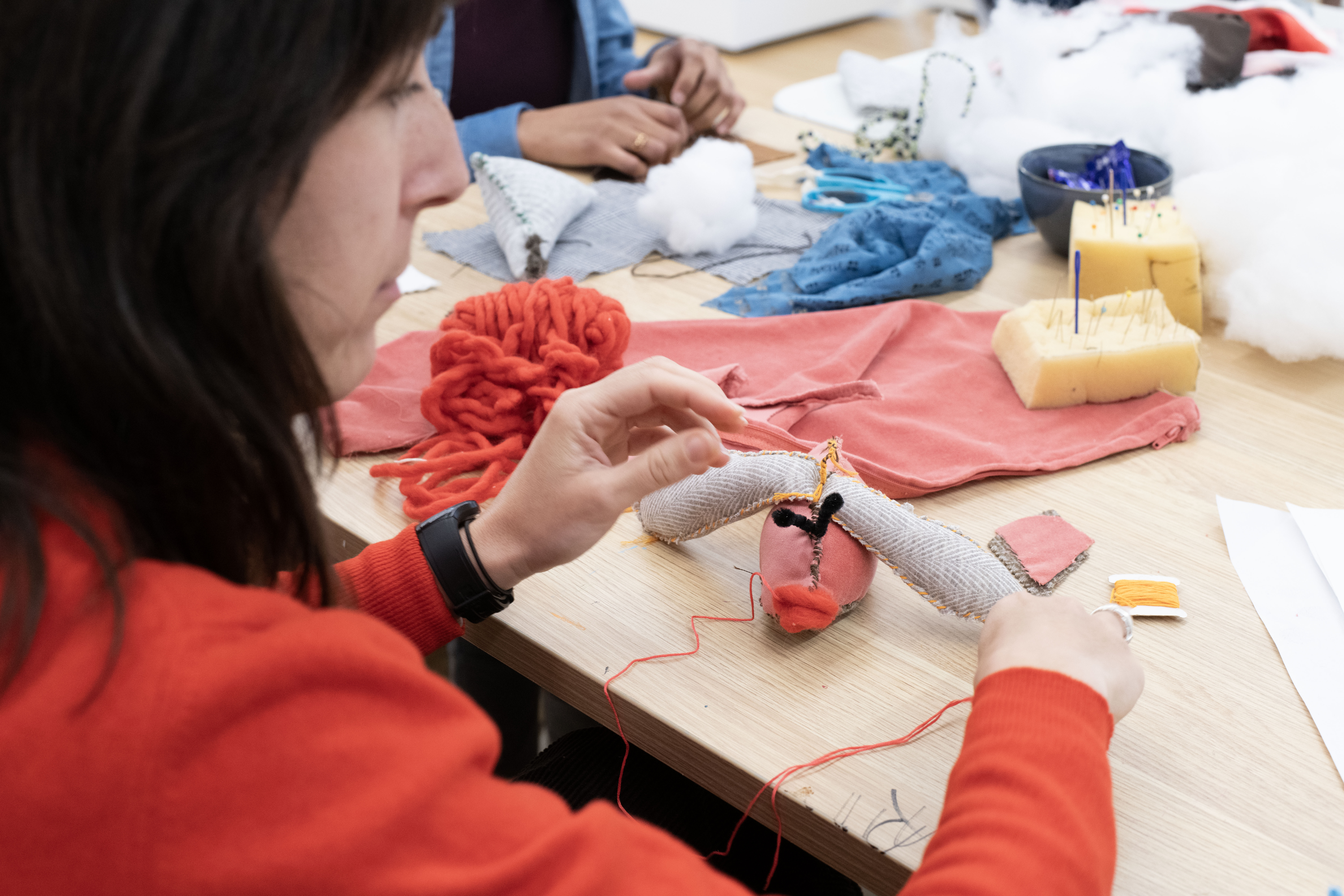 A participant in the Strange Creature Creations Workshop making a fish