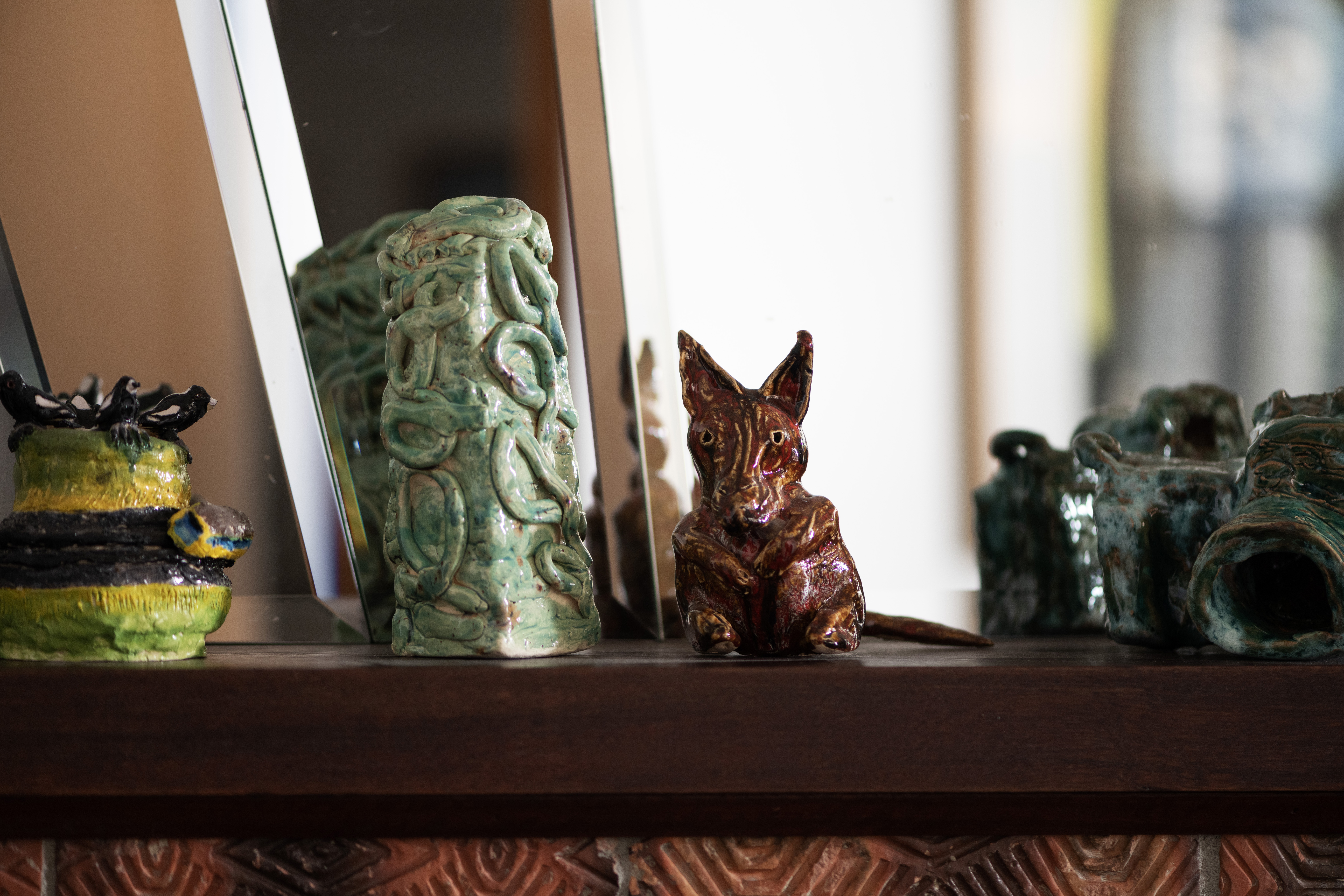 Miles Howard-Wilks, Ruth Howard, Georgia Szmerling and Alan Constable ceramics displayed on a mantle piece
