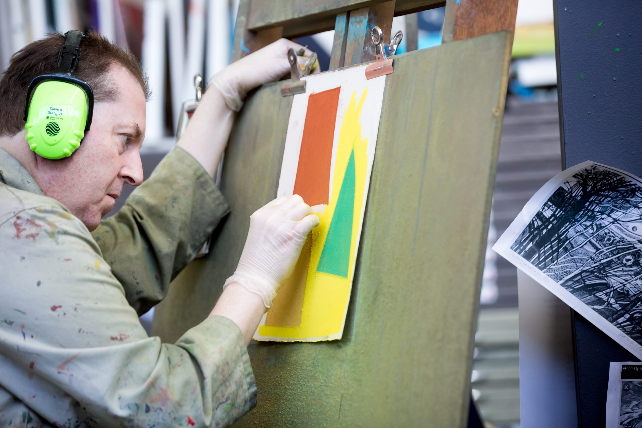 Julian Martin drawing with pastel on paper in the APA studio