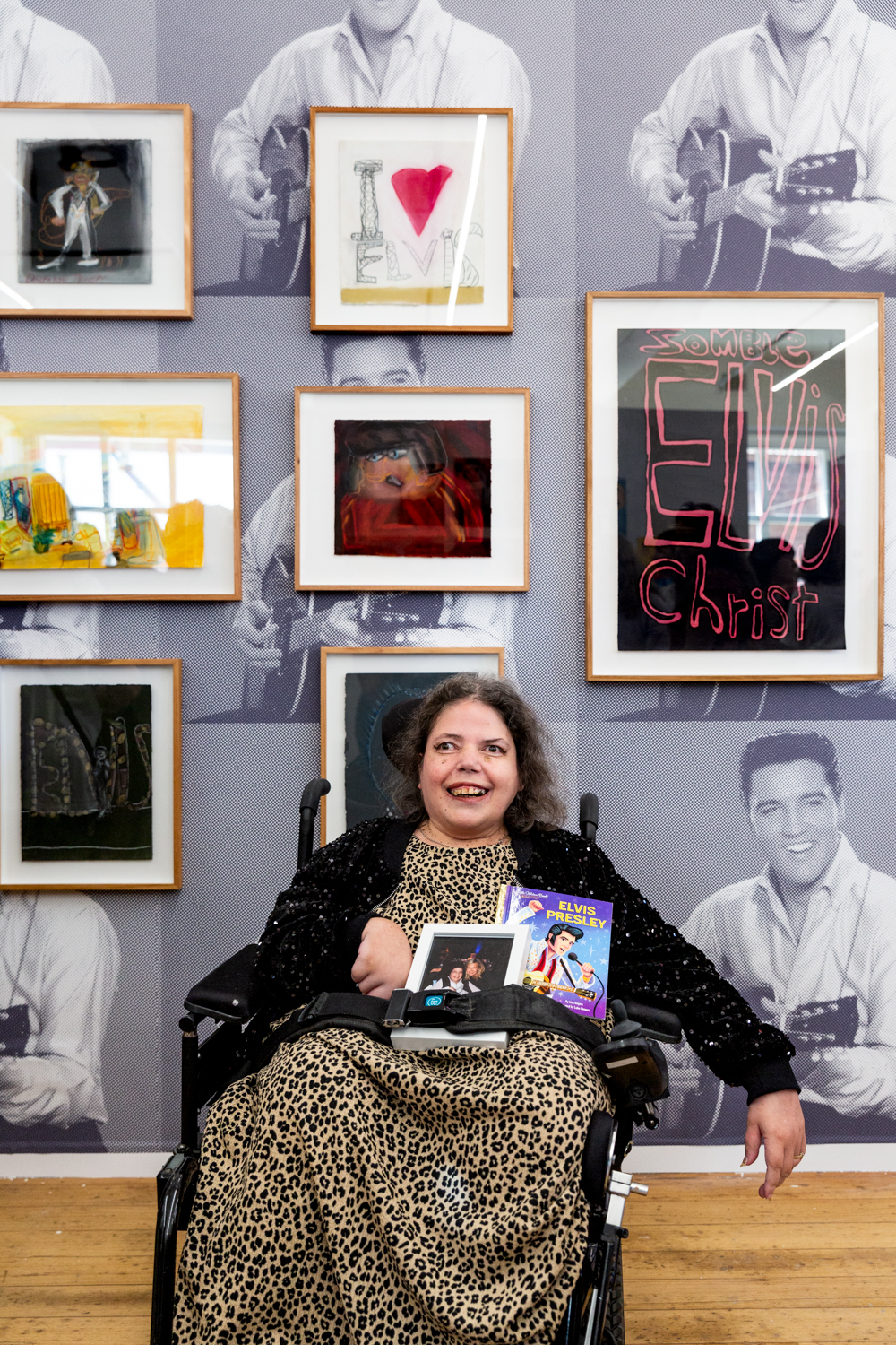 Dionne in the APA gallery pictured with her framed artworks of Elvis Presley