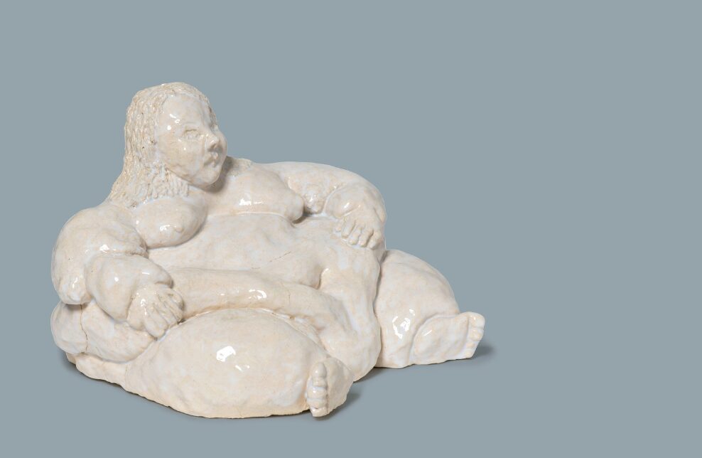 A ceramic sculpture of a lady is placed on a blue background to promote Melbourne Art Fair