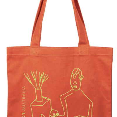 A bright orange tote bag featuring an image drawn by apa artist Peter Ben. The image is a green line drawing of a body.
