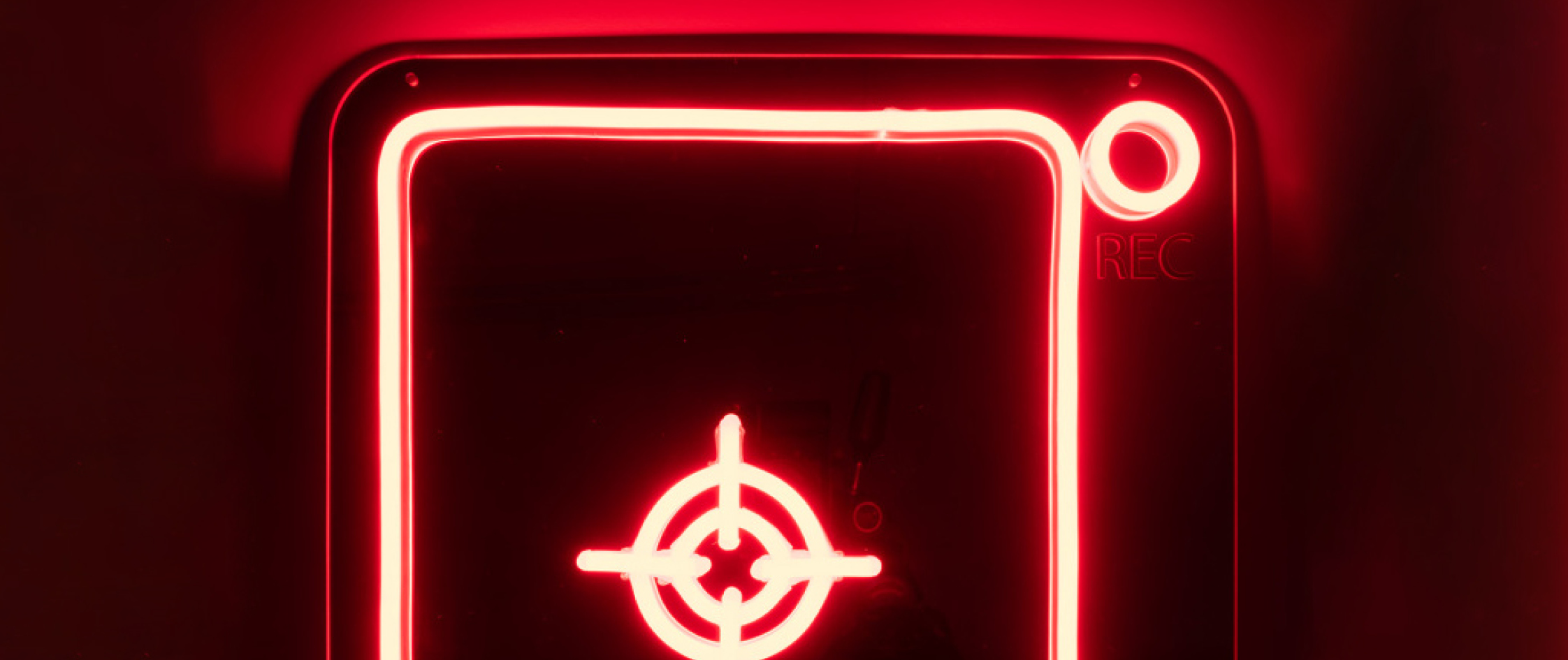 Detail of a neon light artwork by Aiden Sefo that looks like a scanner bed used at checkouts at supermarkets.